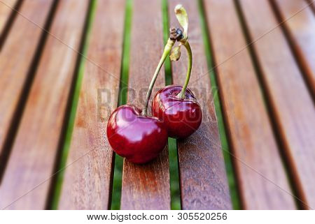 Cherry With Stal On A Wood Background.big Variety Of Cherries. Varieties: Frisco, Red Giant, 3-13, B
