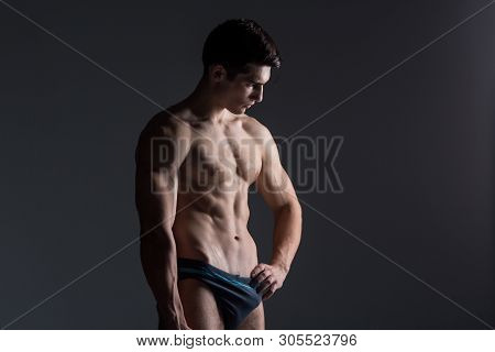 Young Male Athlete Bodybuilder Posing. Handsome Athletic Male Power Guy. Fitness Muscular Person. Yo