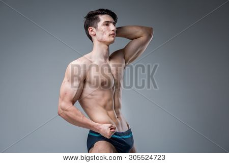 Studio Portrait Young Caucasian Man On Gray Background Posing. Theme Of Puberty, Problem Skin, Teen 