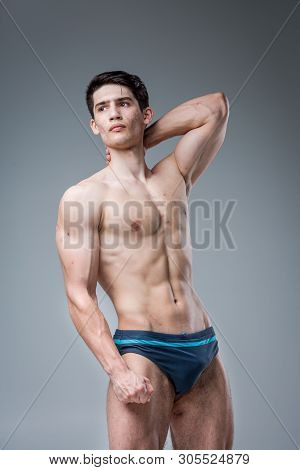 Studio Portrait Young Caucasian Man On Gray Background Posing. Theme Of Puberty, Problem Skin, Teen 