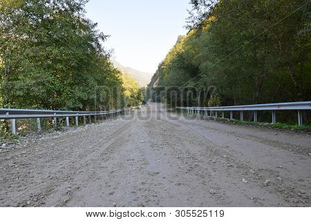 Panorama Mountain Road With Railings Through The Forest In Cherek Gorge In The Mountains Of The Nort