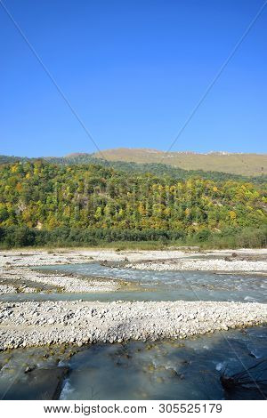 View Of The Fast River With Water, Stones And Mountains With Green Trees In The Cherek Gorge In The 