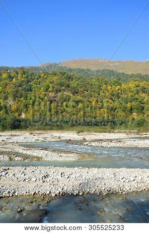 View Of The Fast Mountain River With Stones And Mountains With Green Trees In The Cherek Gorge In Th