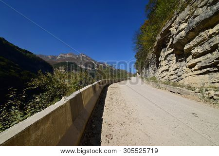 View Of The Mountain Road Through The Gorge With Railings And Rocks In The Cherek Gorge In The Mount