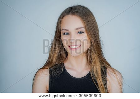 Portrait Of A Cute Blonde Girl Standing On White Background. Close Up Portrait Of Young Cheerful Bea
