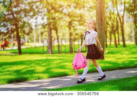 Portrait Of Happy Caucasian Young Smiling Girl Wearing School Backpack Outside The Primary School. S
