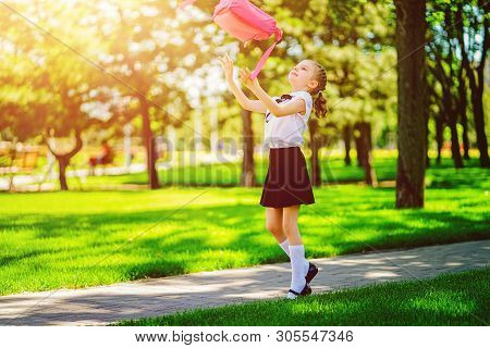 Portrait Of Happy Caucasian Young Smiling Girl Wearing School Backpack Outside The Primary School. S