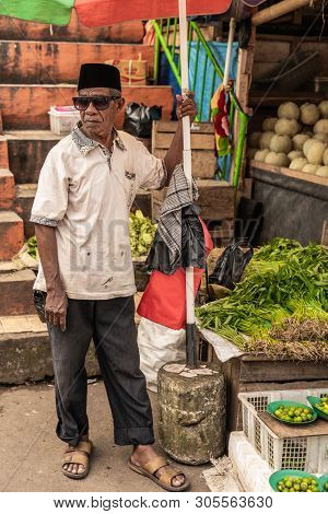 Makassar, Sulawesi, Indonesia - February 28, 2019: Terong Street Market. Older Vendor In Black Pants