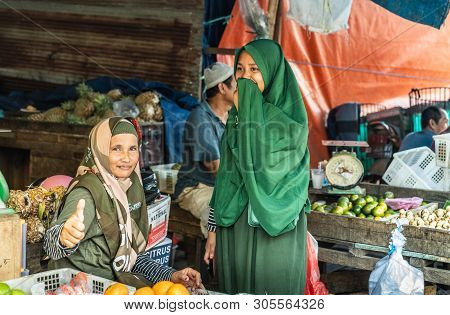 Makassar, Sulawesi, Indonesia - February 28, 2019: Terong Street Market. Young Woman In Green Khimar