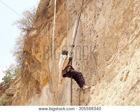 Debre Damo, Ethiopia - 7 June 2019 :monk Climbing A Rock Wall At Debre Damo Monastery, Ethiopia