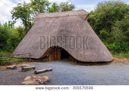 Old Thatch, Straw Celtic Cottage With Camp Fire, Concept Of Early Age Human Settlement, Green Forest