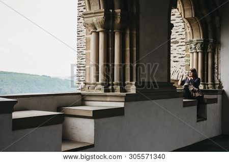 Vianden, Luxembourg - May 18, 2019: Woman Taking Pictures On Mobile Phone From Vianden Castle, Luxem