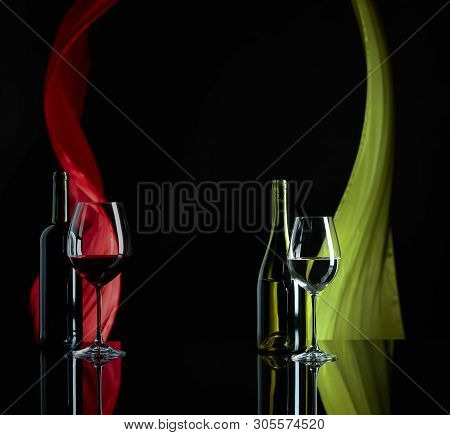 Red And White Wine On A Black Reflective Background. Satin Curtain Flutters In The Wind. Copy Space.
