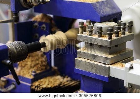 Wood Carving Process Using Woodturning Lathe. Selective Focus.