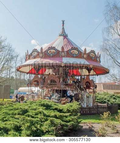 Hodenhagen, Germany, March 30, 2019: Carousel And People On It In The Amusement Park