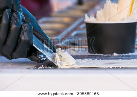 Chef Cooking Asian Natural Stir-fried Ice Cream Rolls At Freeze Pan. Outdoor Cooking, Gastronomy And