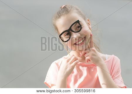 Perfect Props For Partying. Happy Little Child Looking Through Glasses Props. Funny Small Girl Weari