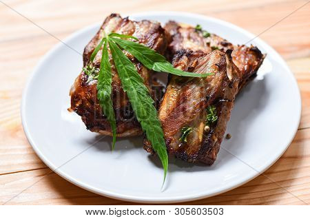 Cannabis Food With Bbq Pork Ribs Grilled With Herbs Spices Served On White Plate / Roasted Barbecue 