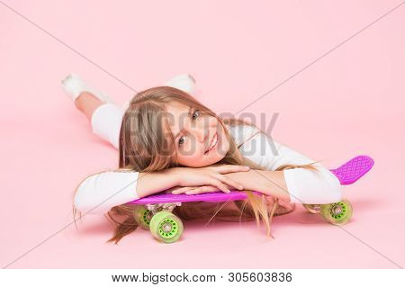 Spreading Happy Vibrations With The Penny Board. Small Girl Skater Relaxing At Penny Board Deck On P