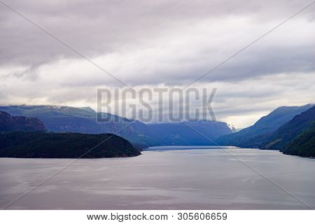 Norwegian Landscape. Green Mountains Hills And Fjord Saudafjord On Overcast Weather. National Touris
