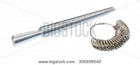 A Ring Sizer And Rings For Measuring Fingers For Ring Size On An Isolated Background.