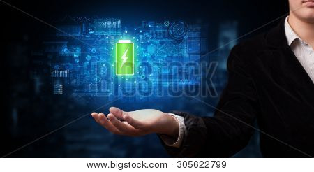 Elegant hand holding battery with full of energy
