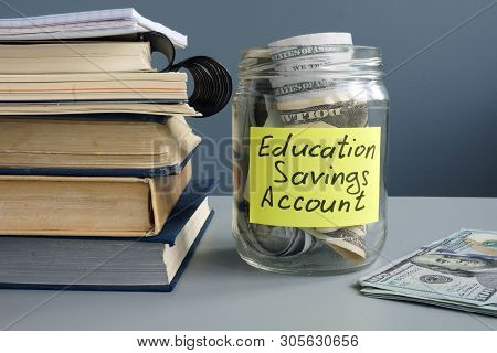 Esa Education Saving Account Label On Jar With Money And Book.