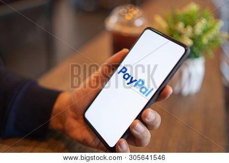 Chiang Mai, Thailand - Mar. 24,2019: Man Holding Xiaomi Mi Mix 3 With Paypal Apps On The Screen. Pay