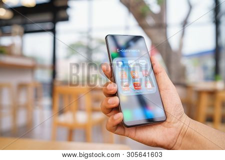 Chiang Mai, Thailand - Mar. 23,2019: Man Holding Xiaomi Mi Mix 3 With Icons Of E-commerce And Online
