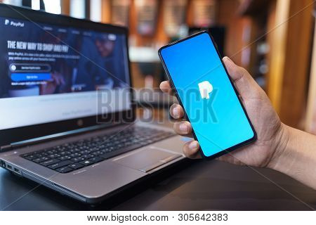 Chiang Mai, Thailand - May.01,2019: Man Holding Xiaomi Mi Mix 3 With Paypal Apps On The Screen. Payp