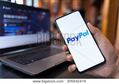 Chiang Mai, Thailand - May.01,2019: Man Holding Xiaomi Mi Mix 3 With Paypal Apps On The Screen. Payp