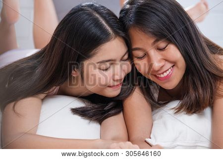 Happy Lesbian Couple On Bed In Bedroom In Morning And Hug Each Other At Home.lgbtq Lifestyle Concept