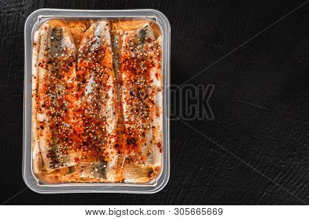 Marinated Fillet Mackerel Or Fillet Herring Fish With Spices Packed In Box On Slate Stone Background