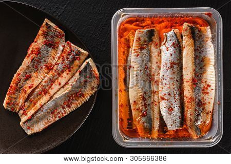 Marinated Fillet Mackerel Or Fillet Herring Fish With Spices Packed In Box On Plate Over Slate Stone