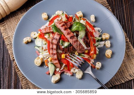 Salad With Grilled Sausage Paprica Cucumber And Croutons