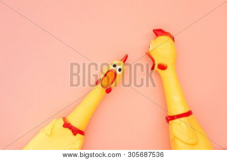 Surprised Chicken Toys Are Isolated On A Pastel Pink Background, One Looks At The Camera And Shouts,