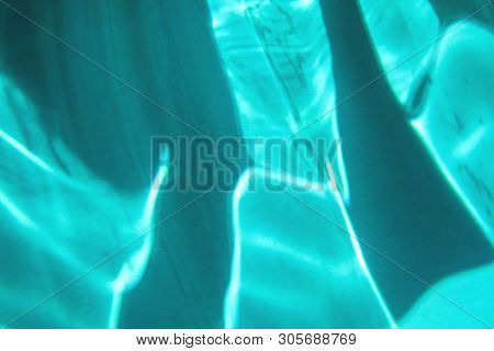 Blue Colored Abstract Background With Light And Shadows Caustic Effect