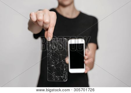 Woman Hands Holding Broken Screen Protection And Saved Smartphone. Phone Save Concept. Isolated On G