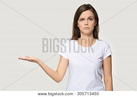 Dissatisfied Woman Showing Empty Open Palm Copy Space Studio Shot