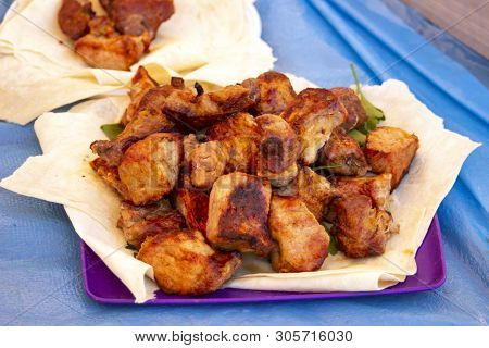 Chopped  Bbq Pieces Of  Mutton, Beef Or Chicken Meat On The Plate With Greenery Outdoor