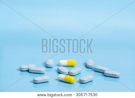 Blue And Yellow Medical Pills On A Blue Background