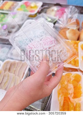 Thai Traditional Dessert, Hand Holding Thai Colorful Coconut Muchkins Or Sticky Rice Balls Stuffed W