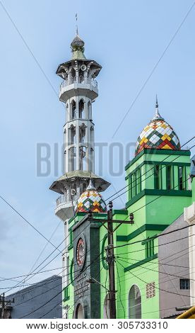 Makassar, Sulawesi, Indonesia - February 28, 2019: Terong Street Market. Minaret And Multi-color Dom