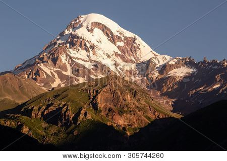 Landscape View Of Mountain Kazbeg On Sunrise, Caucasus Mountains, Country Of Georgia