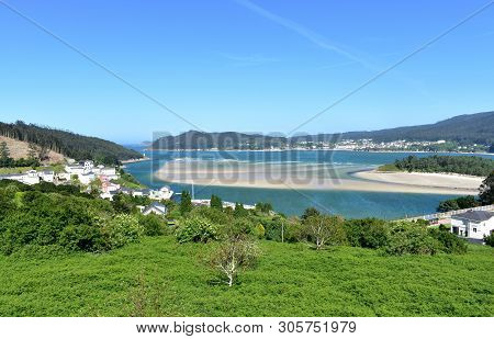 Bay With Small Fishing Village And Beach. O Barqueiro, Spain.
