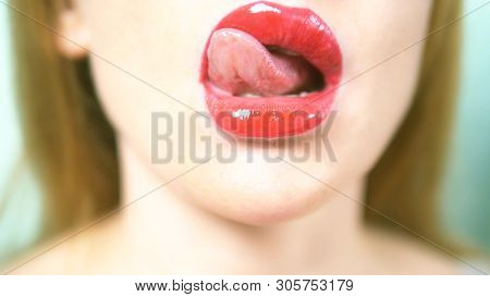 Close-up. Sexy Lips Of A Beautiful Woman With Beautiful Red Makeup, Licks Her Lips