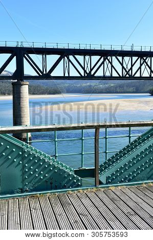 Beach With Old And New Train Bridges. O Barqueiro, Spain.