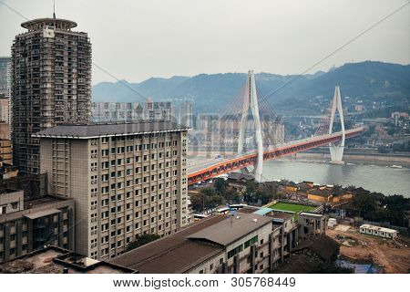 CHONGQING, CHINA â MARCH 13: Dongshuimen Bridge with urban buildings on March 13, 2018 in Chongqing. With 17M population, it is the most populous Chinese municipality.