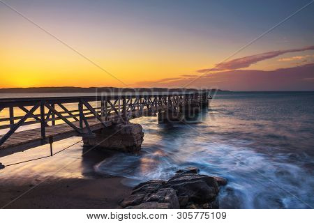 Pier In The Port Of Luderitz At Sunset. Luderitz Is A Harbour Town In The Karas Region Of Southern N