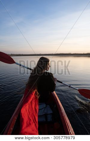 Back View Of Happy Cute Girl Holding Paddle In A Kayak On The River